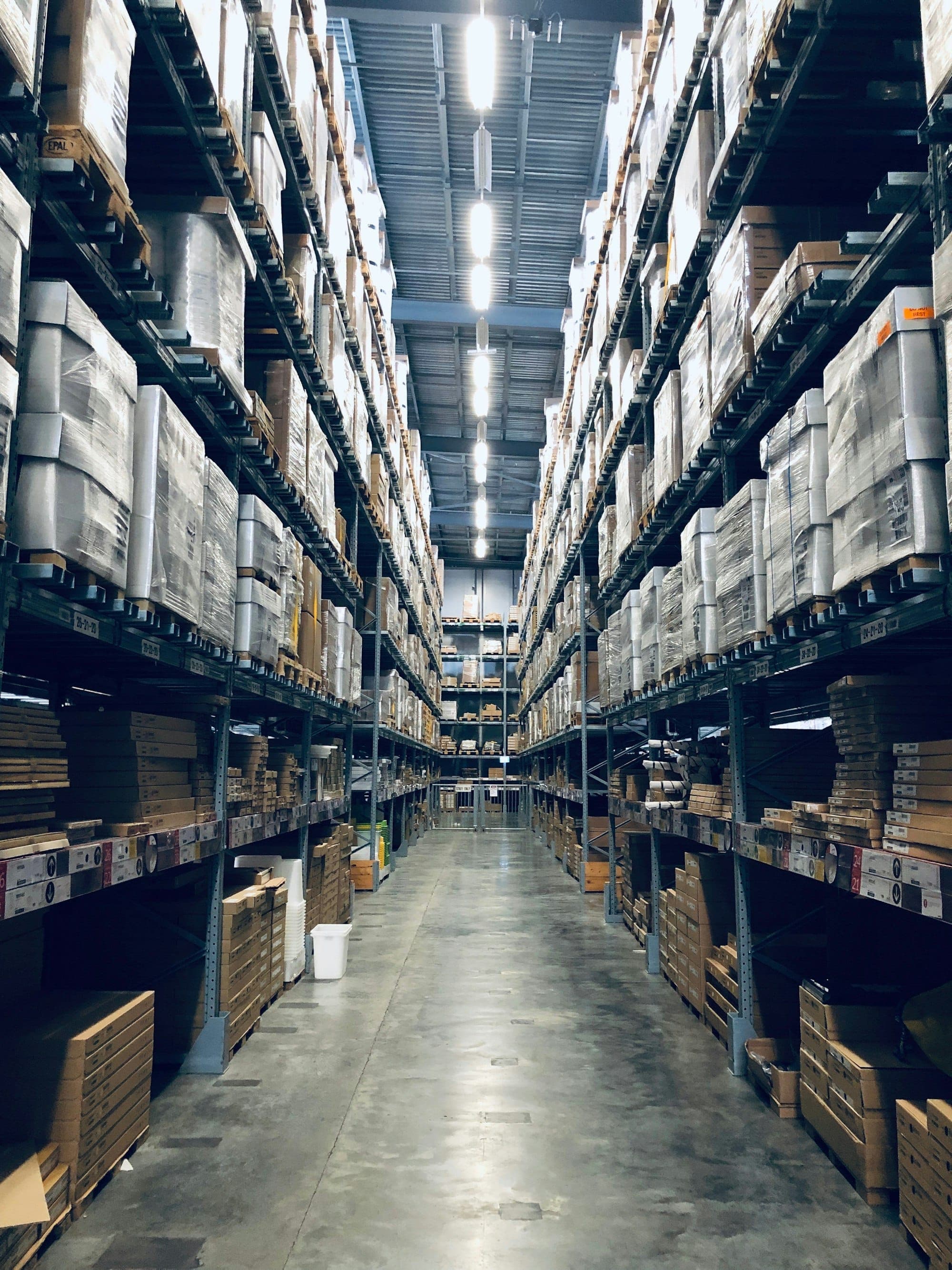 Palletised apparel cartons staged in a consolidation warehouse